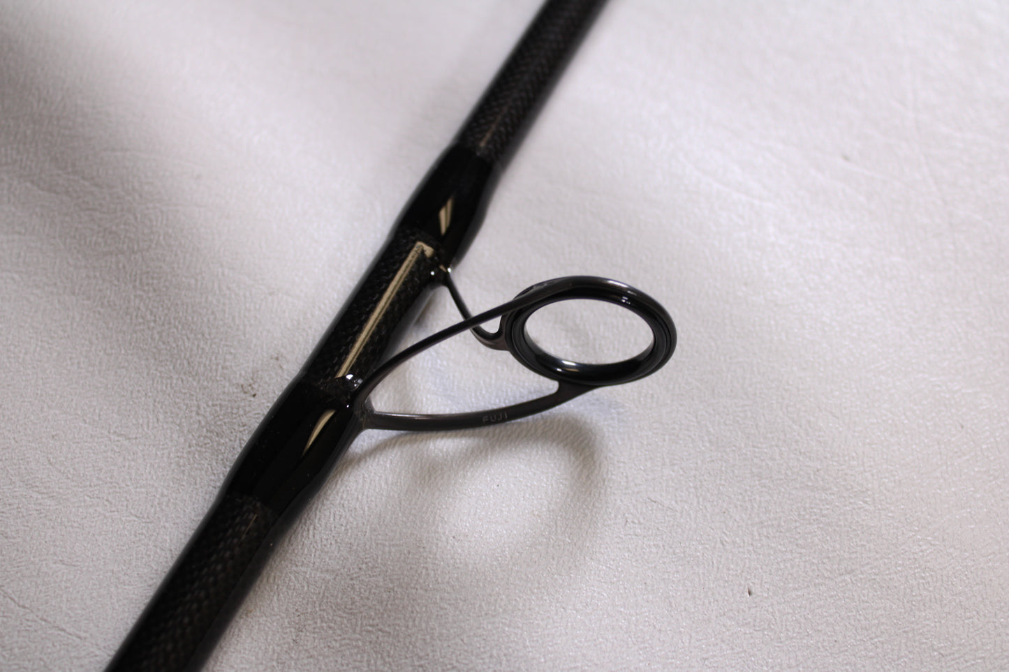 Close-up of the guide ring on an ODM Rods Frontier X NXFX-1066 10'6" Used Spinning Rod in mint condition, showing detailed construction—perfect for those considering our Rod and Reel Trade-In Program.