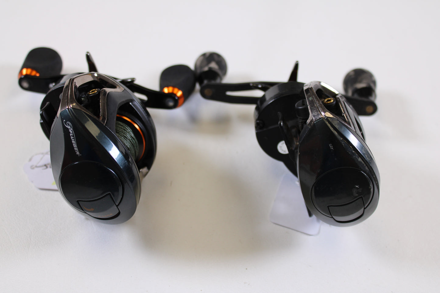 Two used Pflueger Supreme XT casting reels—SUPXT71LP 7.1:1 RH and SUPXT64LP 6.4:1 RH, both in good condition—are shown together, perfect for earning store credit with our Rod and Reel Trade-In Program.