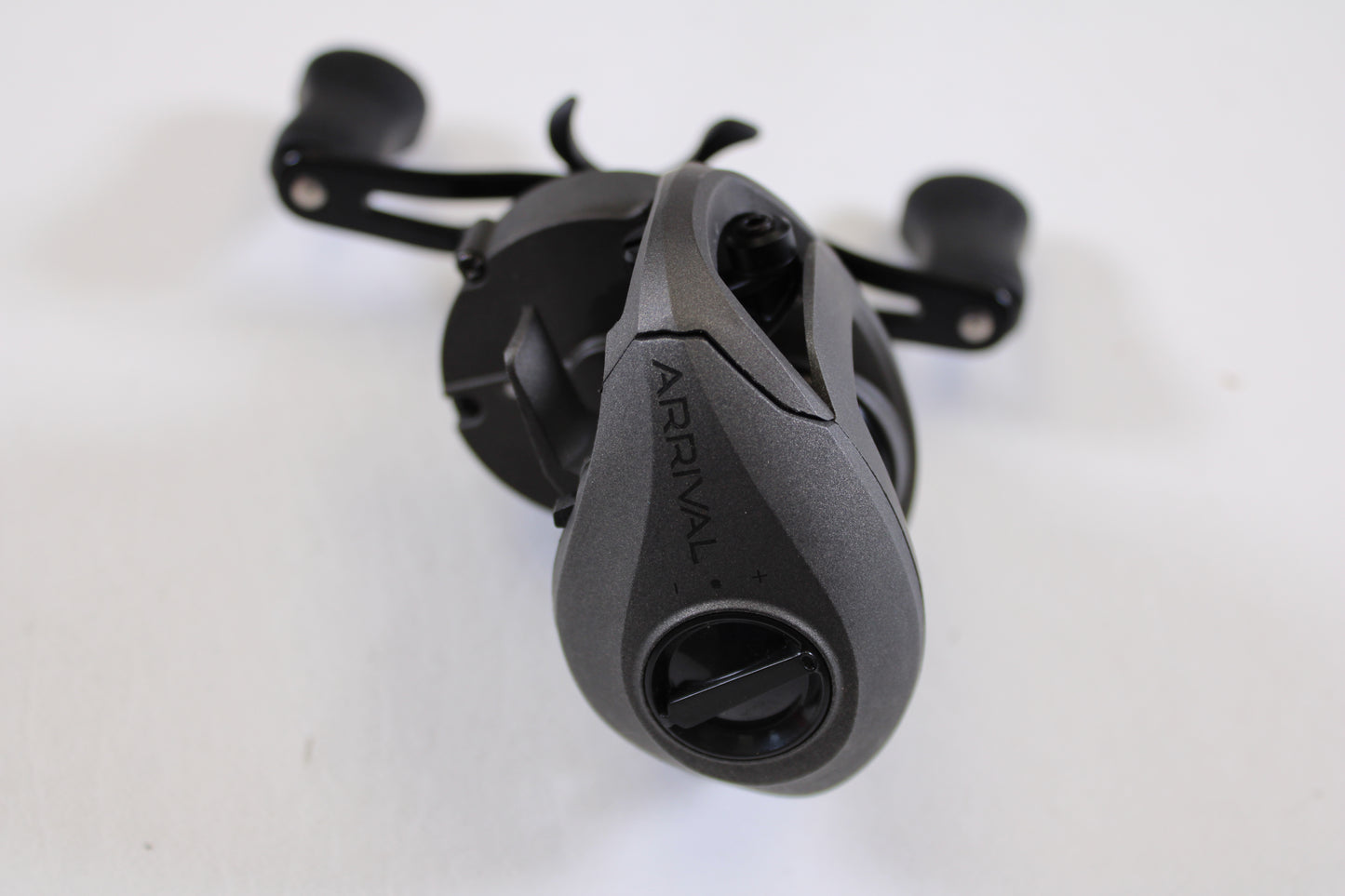 A close-up of a SixGill Arrival Series 6 7.0:1 RH Used Casting Reel in excellent condition, featuring a sleek, ergonomic black design—ideal for our Rod and Reel Trade-In Program or earning store credit on used gear.