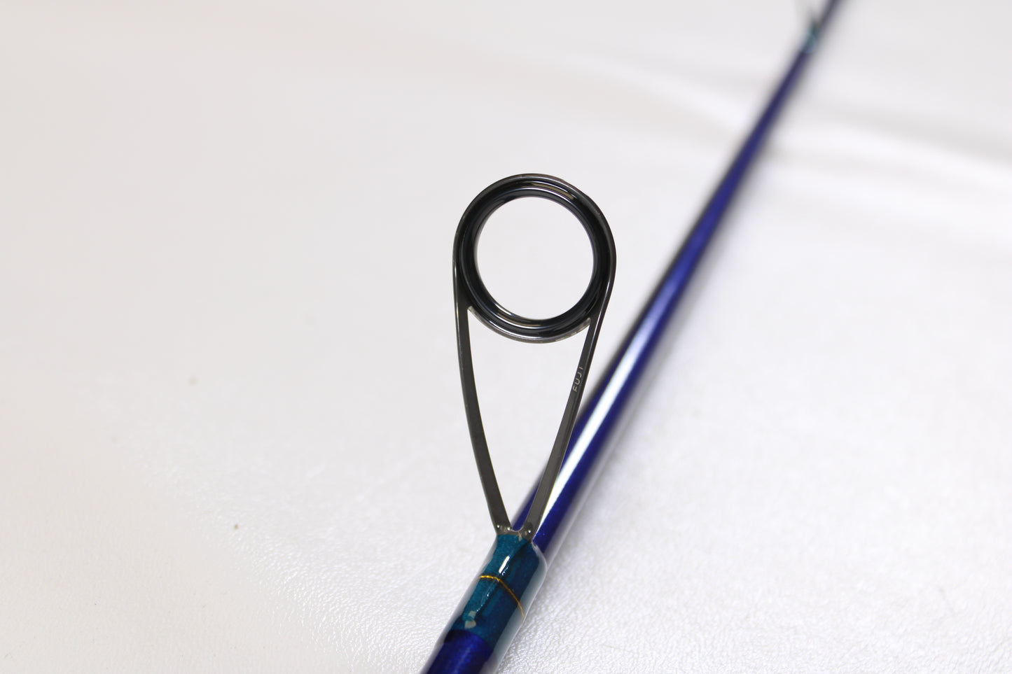 Close-up of a St. Croix Legend Tournament Inshore ITLS76MF 7'6" medium used spinning rod in mint condition, highlighting a single black line guide on a plain white background—ideal for our rod and reel trade-in program.