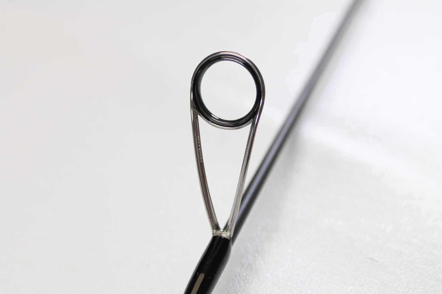 Close-up of the eyelet and metal frame on the Raid Japan Gladiator Maximum GX-59XLS-AS Solid Maxx XL 5'9" Extra Light Used Spinning Rod—shown in mint condition, perfect for our Rod and Reel Trade-In Program.