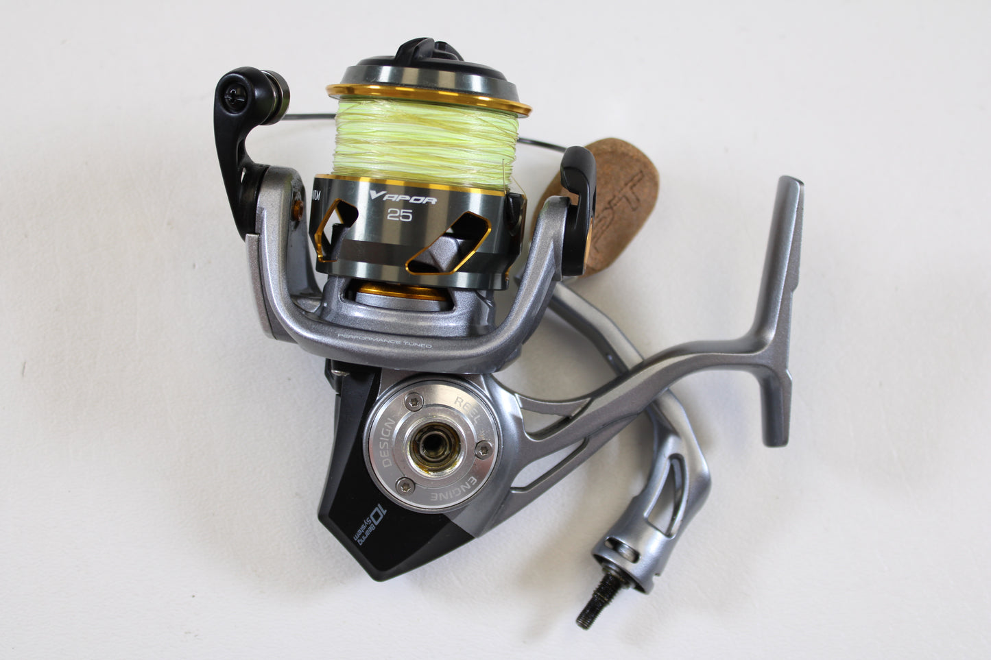 A close-up of the Quantum Vapor PT VP25XPT 6.0:1 Used Spinning Reel in excellent condition, featuring yellow line and the "Vapor 25" label—ideal for those interested in quality used gear or our Rod & Reel Trade-In Program.