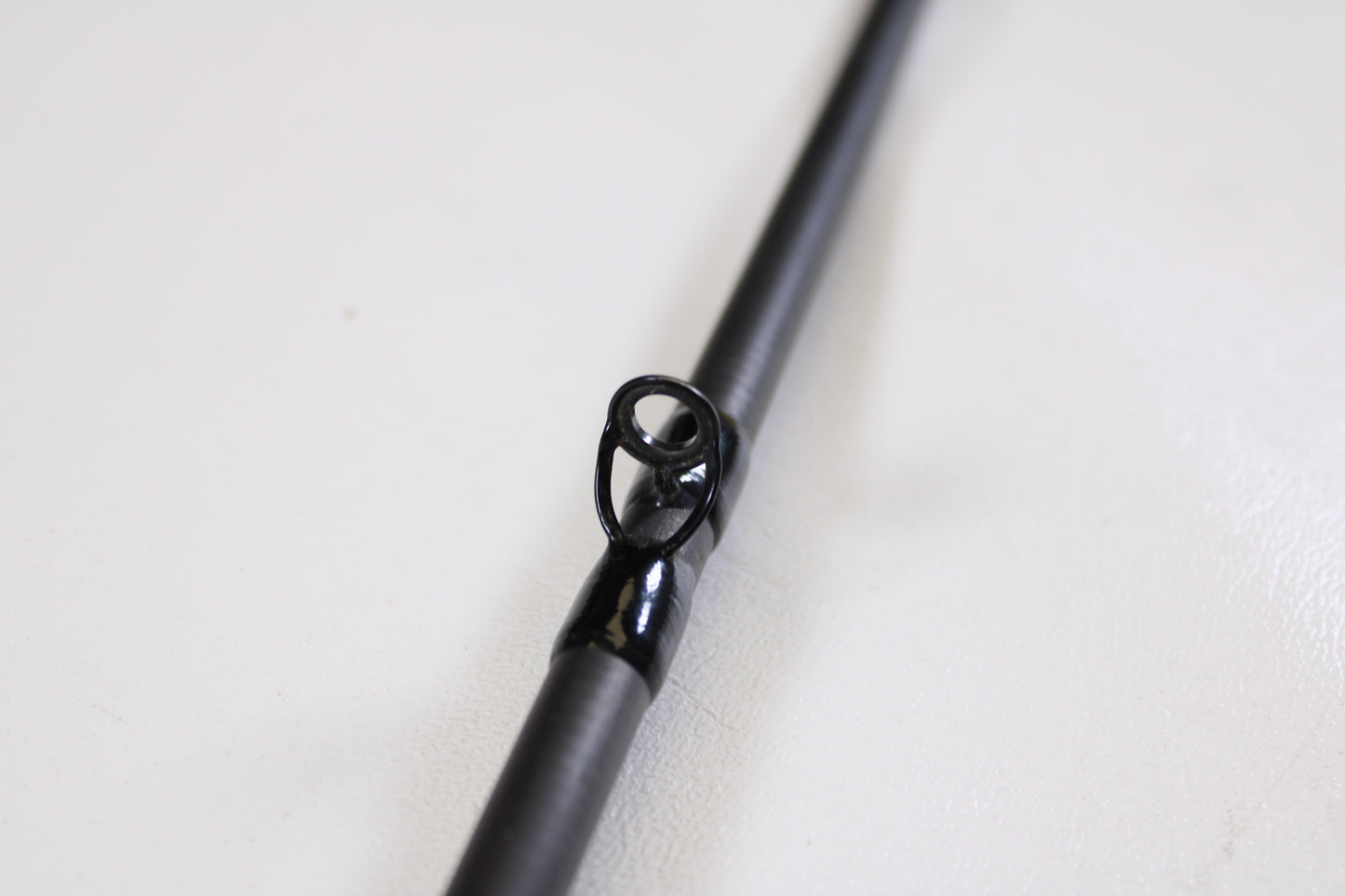 Close-up of the Shimano Intenza A NTZC72MHA 7'2" Medium Heavy Used Casting Rod’s guide, highlighting the black metal ring—ideal for anglers seeking quality used gear or trading in rods and reels for store credit.