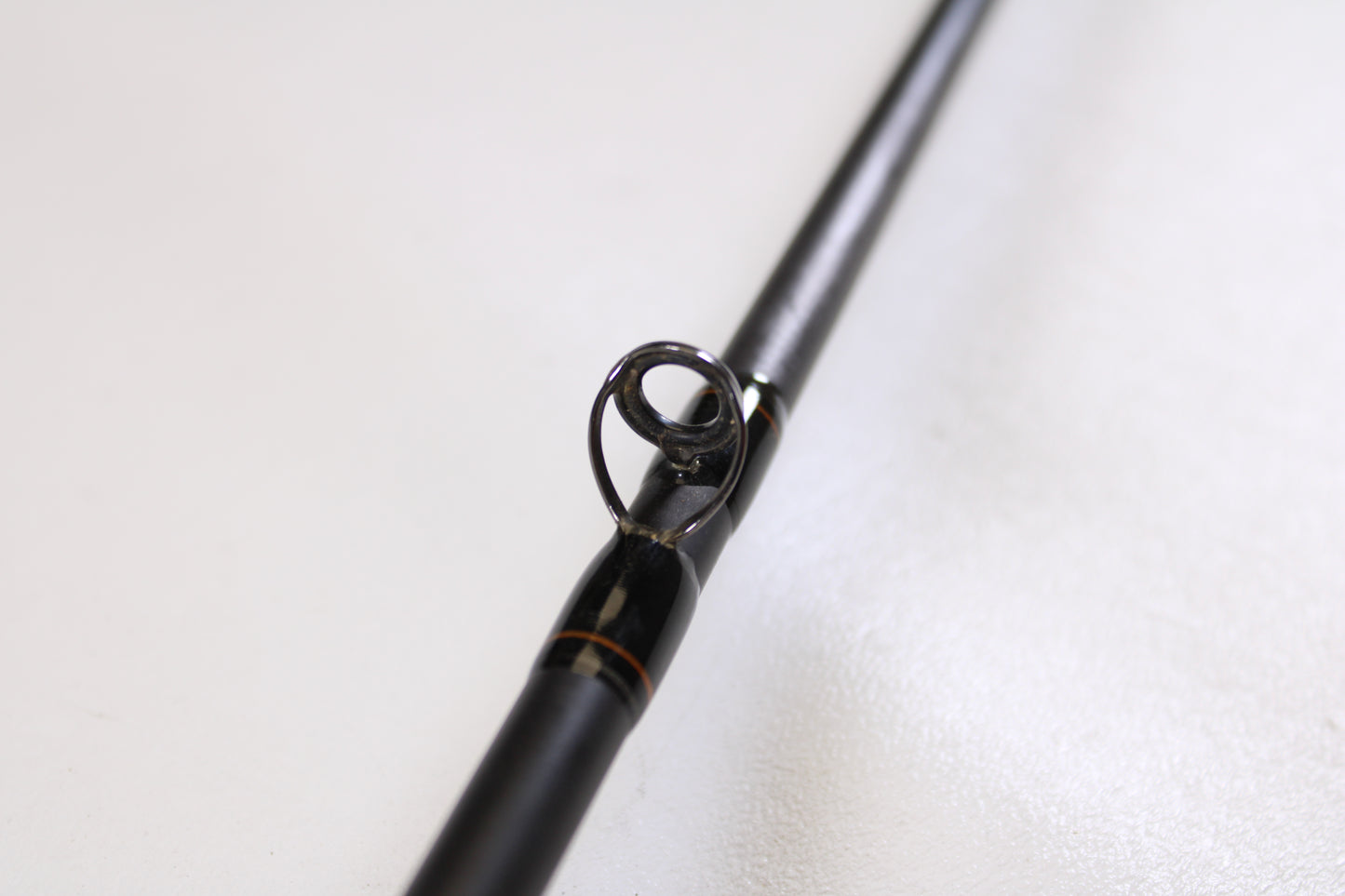 Close-up of a Spiralite Defiant SDC66MF 6'6" Medium Used Casting Rod in excellent condition, highlighting a line guide against a neutral background—ideal for those seeking quality used gear or considering a rod trade-in for store credit.