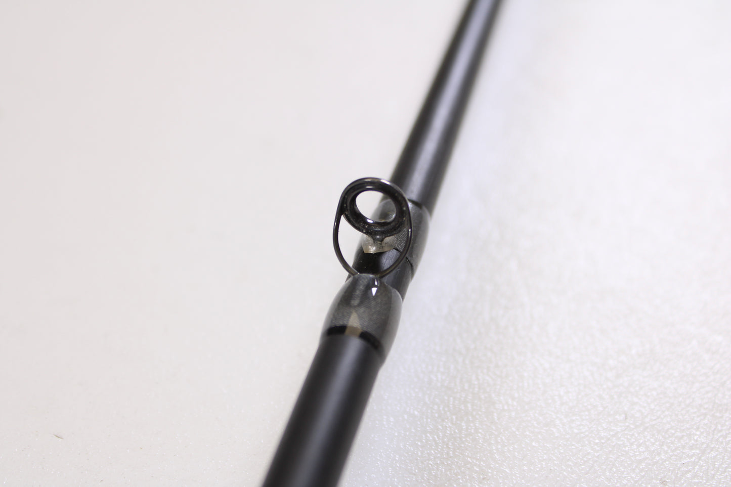 Close-up of the guide ring on the Stik5 Elevate Series The One 7'3" Medium Heavy Used Casting Rod in excellent condition—ideal for anglers seeking top-quality pre-owned gear from Stik5.