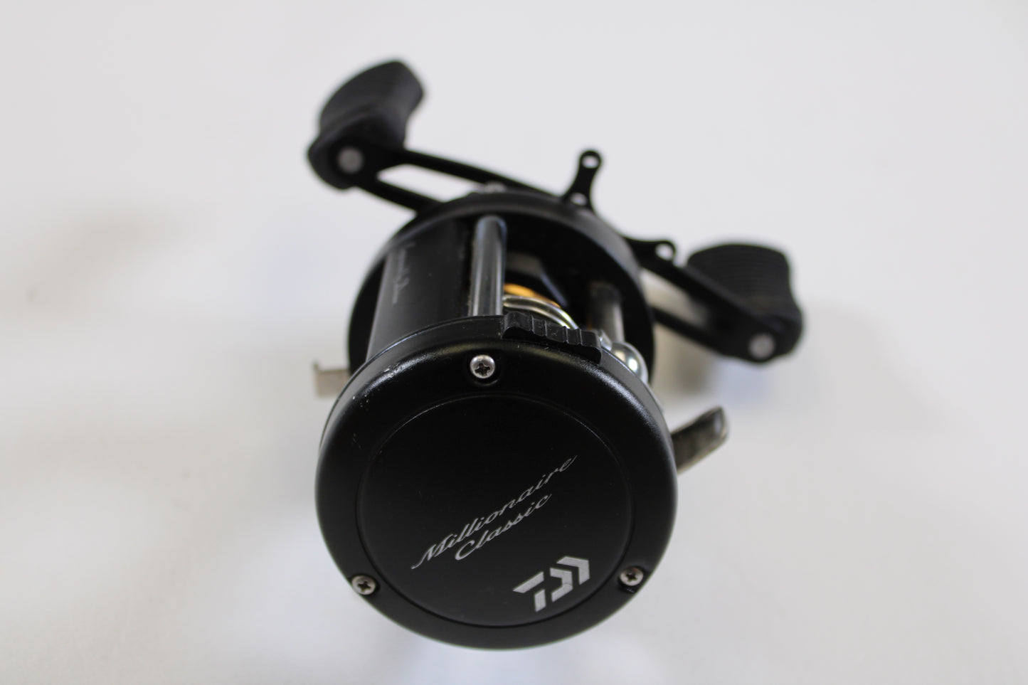 A used Daiwa Millionaire Classic UTD M-CUTD250L 5.1:1 LH casting reel in good condition is shown on a white background—ideal for upgrading through our Rod and Reel Trade-In Program or earning store credit for your used fishing gear.