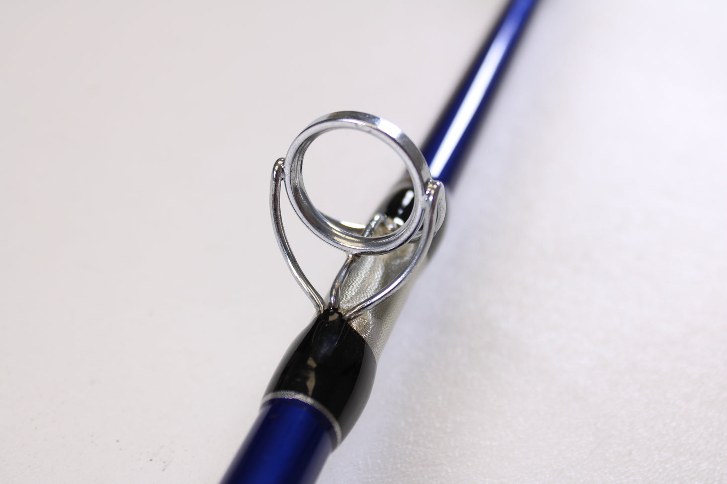 Close-up of a Shattered Cat 7'6" Heavy Used Casting Rod in excellent condition, highlighting a metal line guide—ideal for our Rod and Reel Trade-In Program if you're upgrading your Shattered Cat gear.