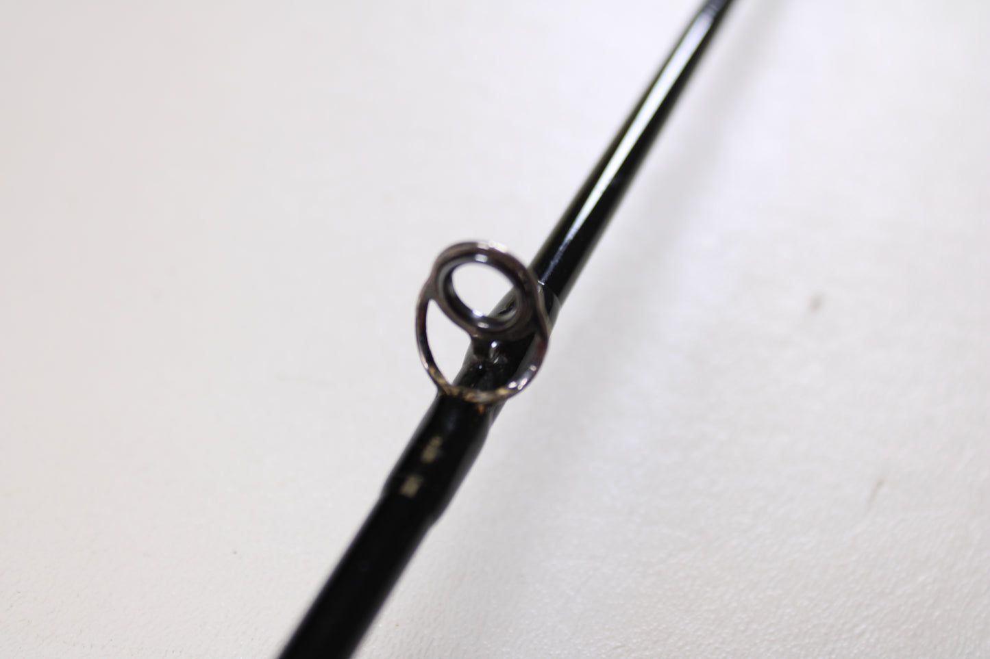 Close-up of the Greys GS2 7'6" 3wt 4 Piece Used Fly Rod (Very Good Condition), highlighting the black guide’s circular metal ring—ideal for anglers considering our Rod and Reel Trade-In Program to upgrade their gear.