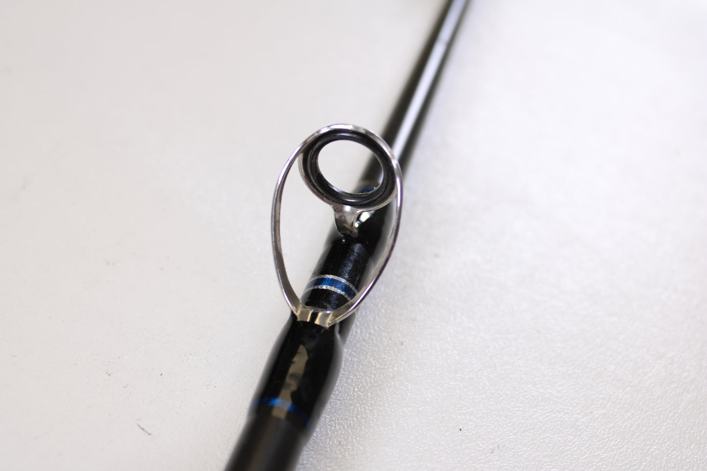 Close-up of two used Okuma Cedros Jigging 6'6" medium casting rods in excellent condition, featuring metallic guide rings and blue accents. Trade in your old gear for store credit with our rod and reel trade-in program.