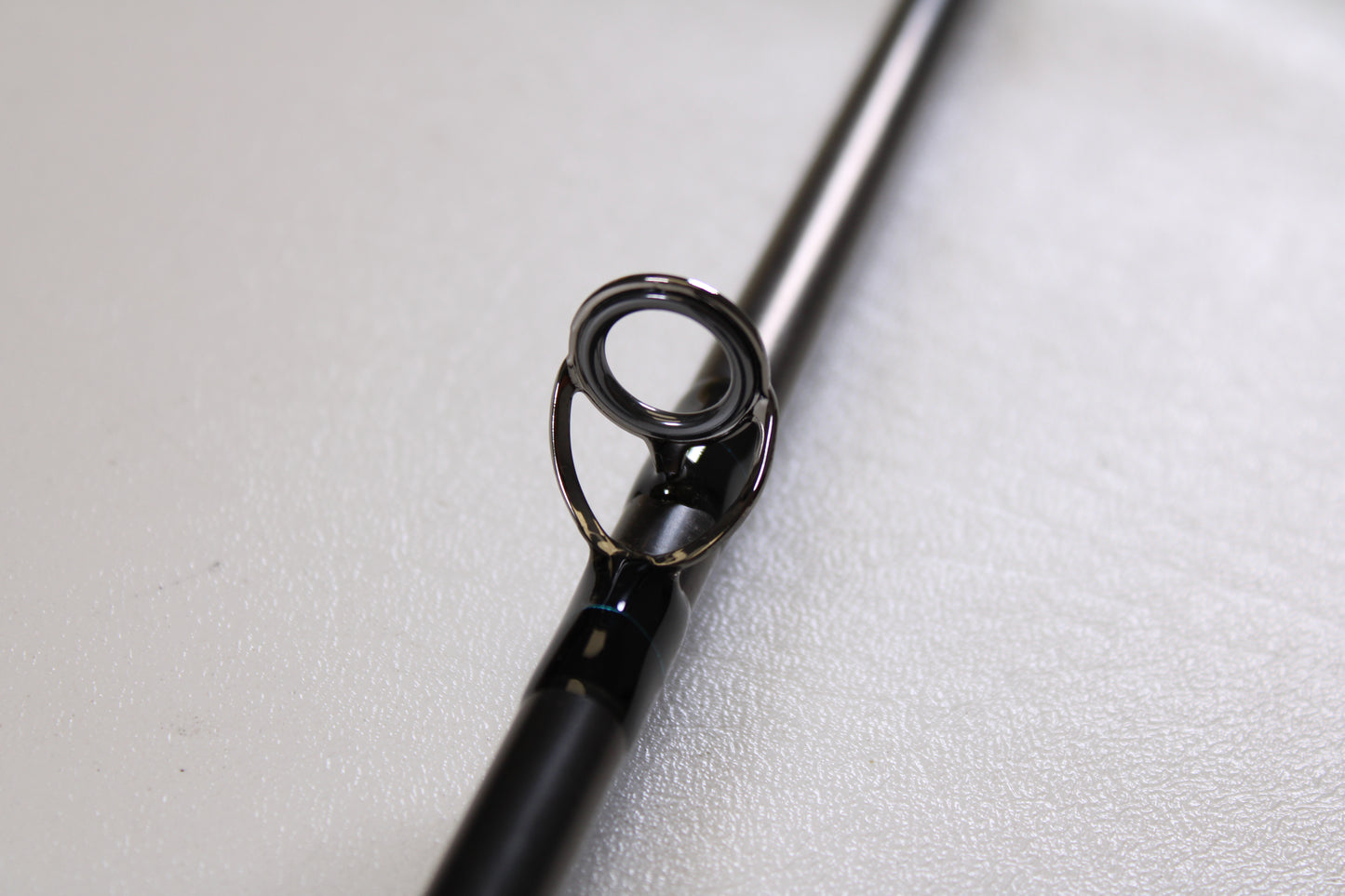 Close-up of a G. Loomis GLX FR1209 10'0" #9 2 Piece Used Fly Rod in excellent condition, highlighting its metal guide ring—ideal for trading in through our Rod and Reel Trade-In Program for store credit.
