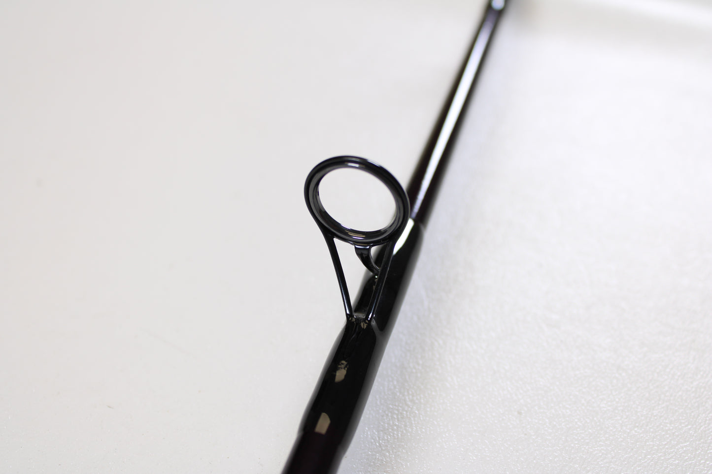 Close-up of a St. Croix Mojo Jig MJJS58XHMF 5'8" XH spinning rod guide, showing its circular eyelet and frame—ideal for anglers seeking used gear or a trade-in for store credit. Mint condition from St. Croix.