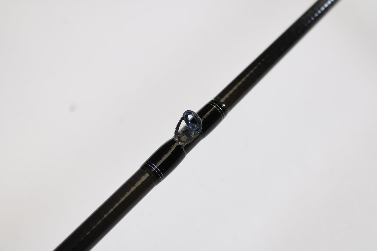 Close-up of a Daiwa Tatula TTU711HFB Used Casting Rod in mint condition, highlighting a line guide against a white background—ideal for those upgrading gear with our trade-in program for store credit.