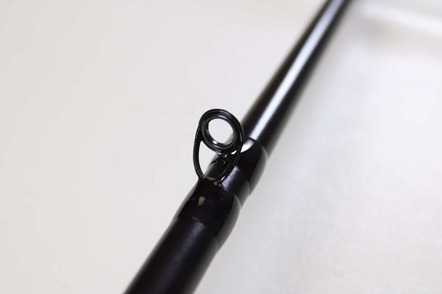 Close-up of the St. Croix Mojo Bass JOC710XHF Mid Swimbait 7'10" XH Used Casting Rod in mint condition, highlighting a line guide—great for highlighting your gear when trading in rods through our Rod and Reel Trade-In Program for store credit.