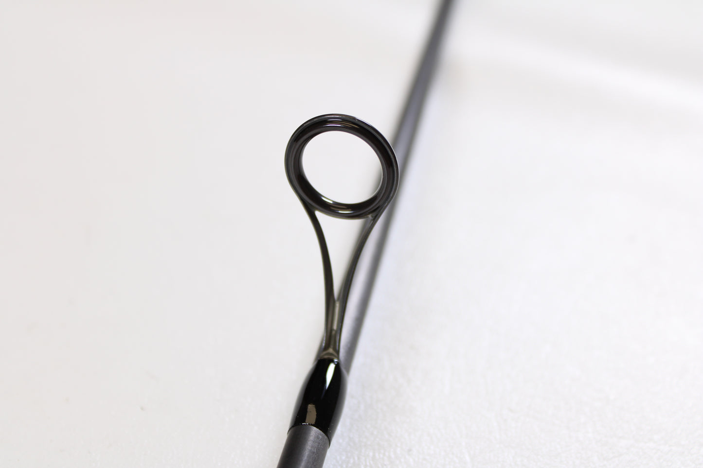 Close-up of a G. Loomis E6X Walleye 782S WUR 6’6” Medium Used Spinning Rod’s guide, highlighting the circular metal ring and support—ideal for anyone seeking quality used gear from G. Loomis in mint condition.