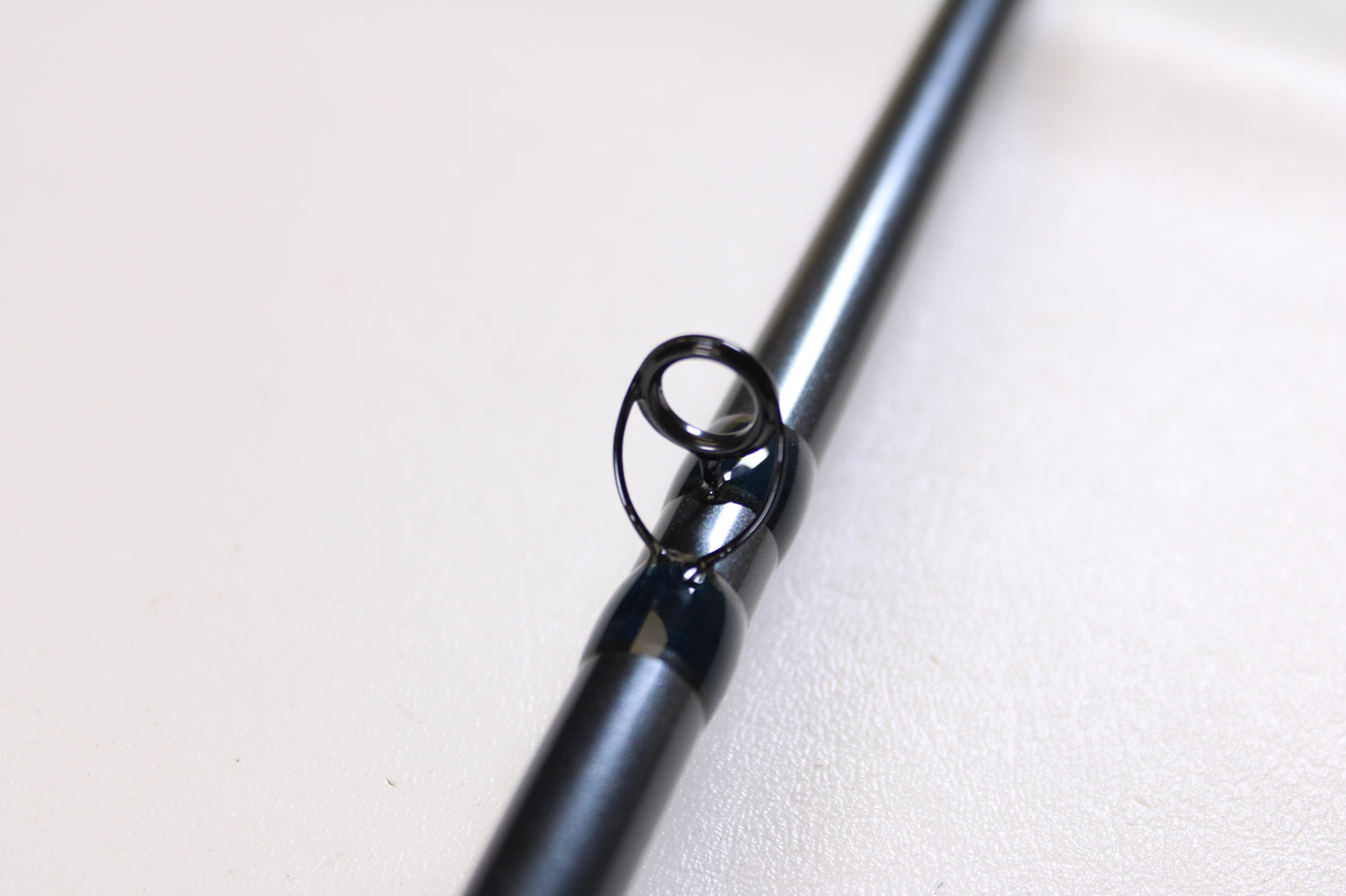 Close-up of a G. Loomis Salmon & Steelhead Mooching SAMR1265C 10'6" Heavy Used Casting Rod guide—ideal for anglers seeking a top-quality, mint condition upgrade for salmon and steelhead fishing.
