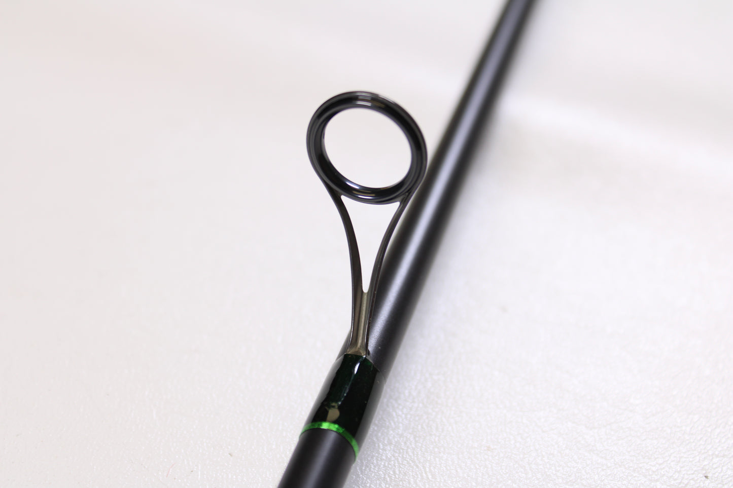 Close-up of a G. Loomis IMX-PRO Steelhead Centerpin 11'4" Medium Light 2 Piece Spinning Rod (Used, Mint Condition), showcasing a metal line guide—ideal for our Rod and Reel Trade-In Program if you’re upgrading your gear.