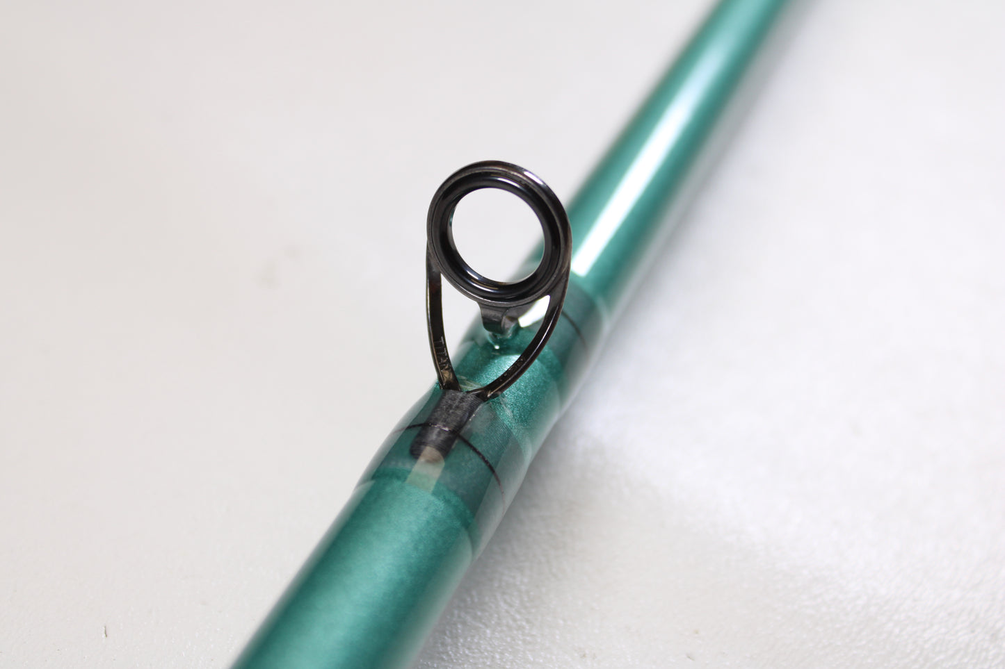 Close-up of the St. Croix Avid Inshore VIC80HF 8'0" Heavy used casting rod in mint condition, featuring a green finish and a single metal guide loop against a plain white backdrop—perfect for trade-in or used gear programs.