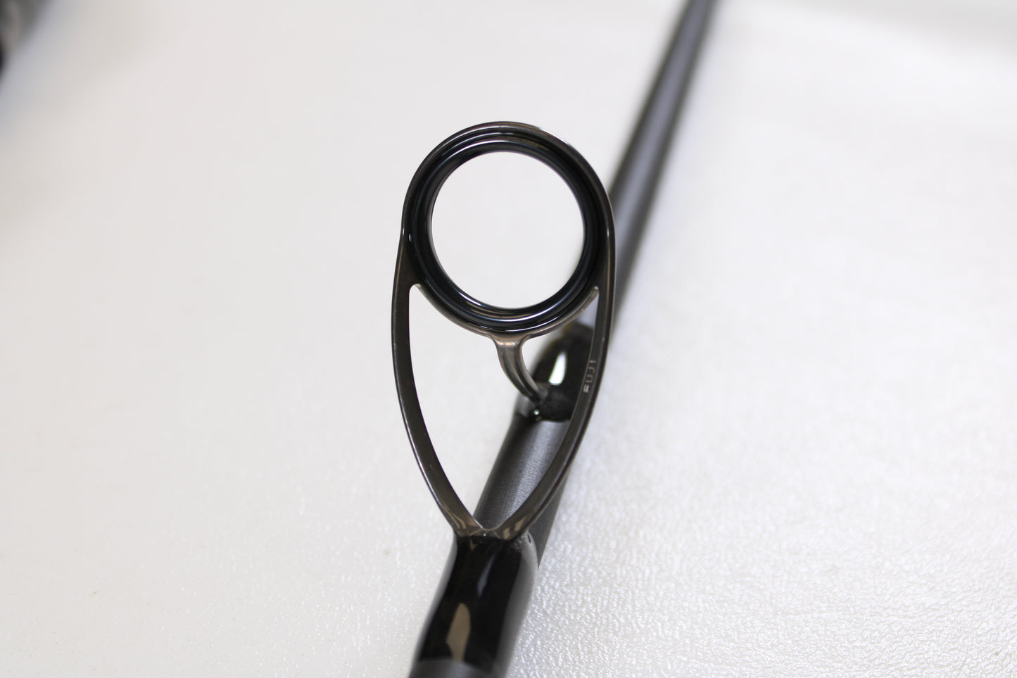 Close-up of the St. Croix Avid Surf VSS90MMF2 9'0" Medium used spinning rod guide, featuring its circular metal ring and support—ideal for enthusiasts interested in high-quality, mint-condition gear or trade-ins.