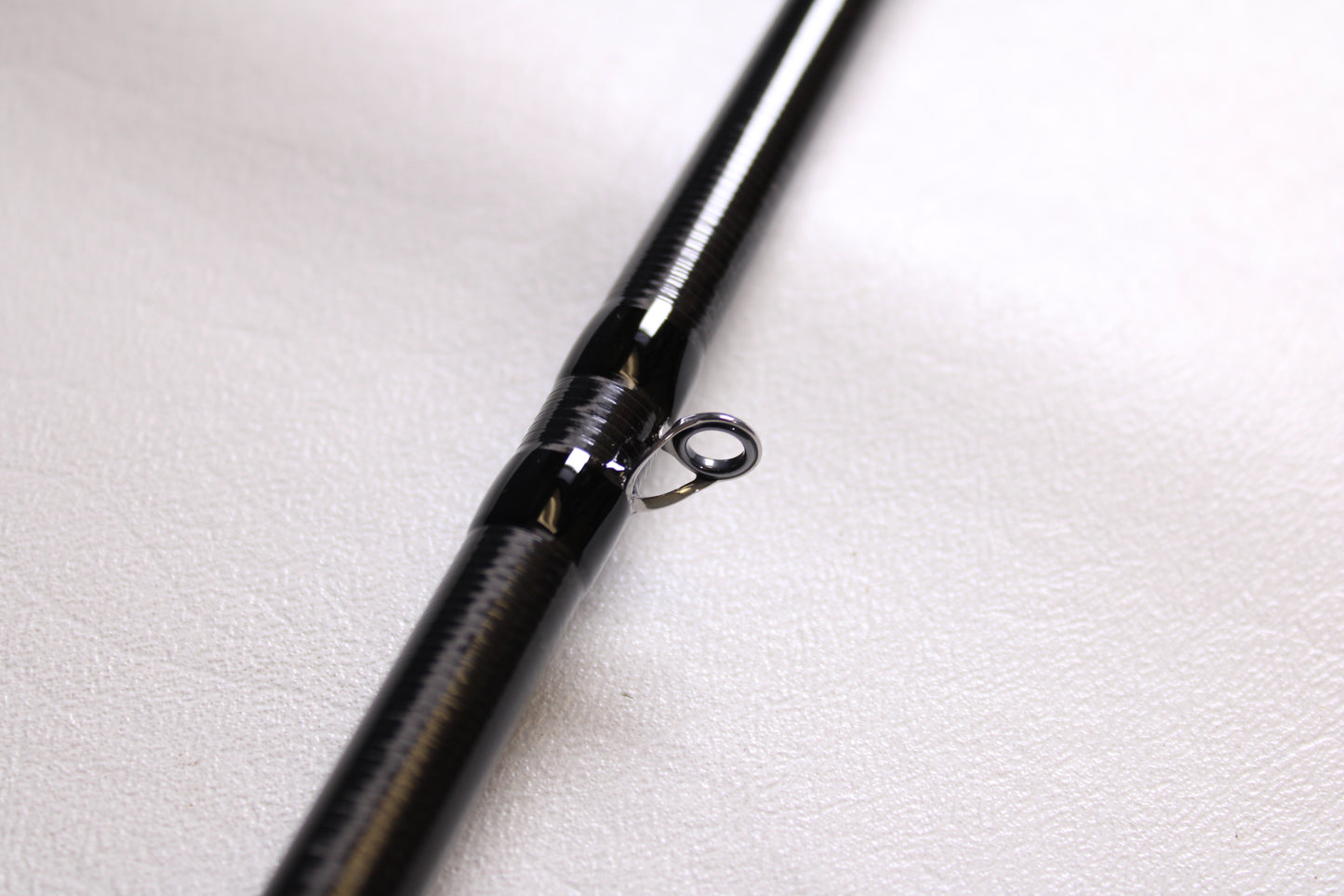 Close-up of a 13 Fishing Envy Black 3 EB3C76MH 7'6" Medium Heavy Used Casting Rod in mint condition, highlighting the metal guide ring—ideal for upgrading with our used gear or rod and reel trade-in programs.