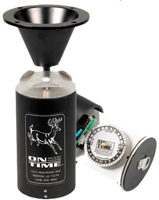 The On Time Game Feeder Lifetime Timer Only is a black cylindrical timer with a funnel top, dial, and deer graphic label. Shown with its lid removed to display internal components. Brand: On Time.