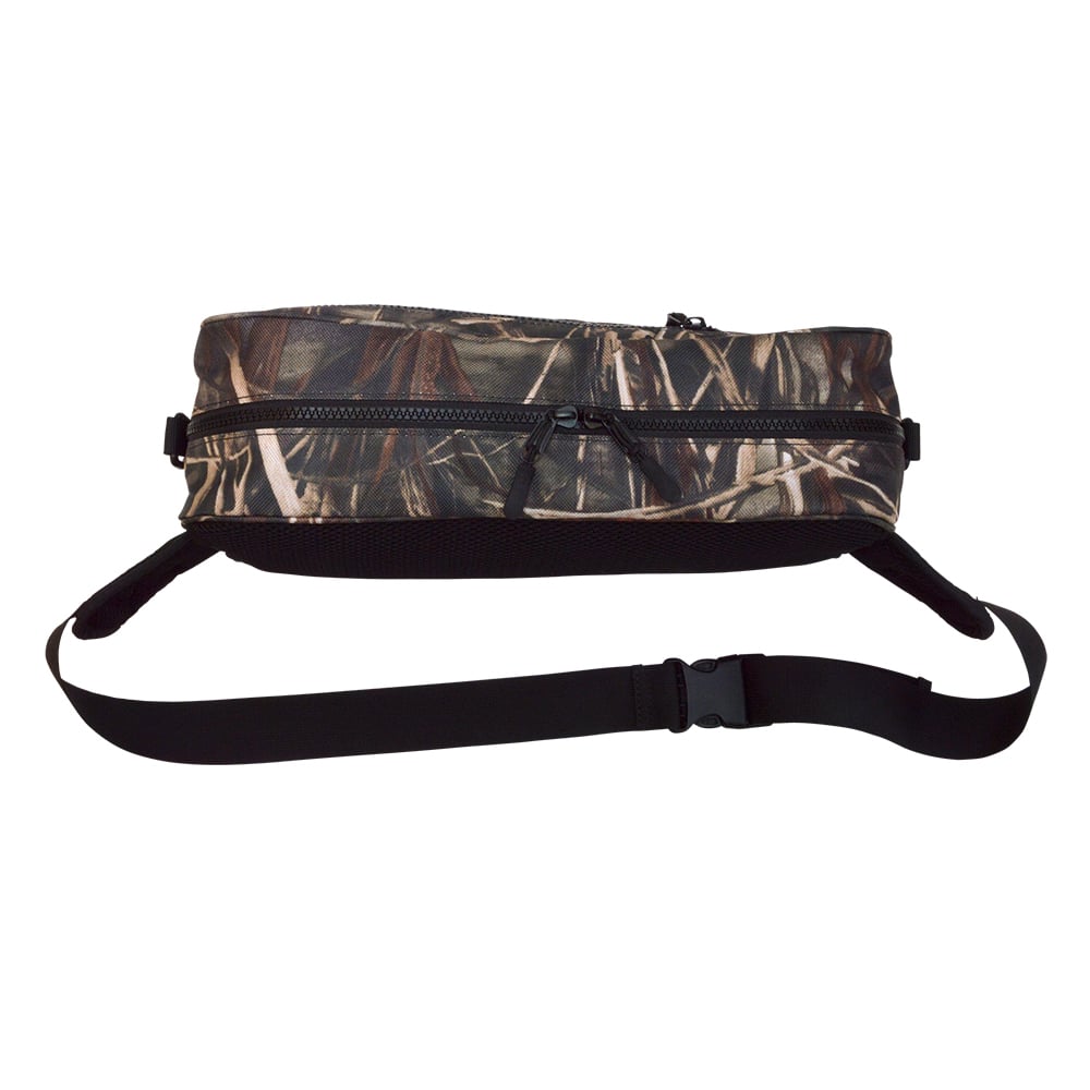 The Megabass Rapid Bag Real Camo (0426234979) is a fanny pack ideal for shore fishing, featuring a large capacity with brown and green camo design. It includes a zipper pocket and an adjustable black strap with buckle clasp, delivering a forest or military aesthetic.