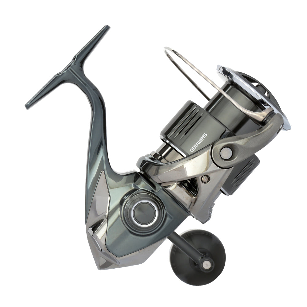 The Shimano Stella FK Spinning Reel 5000XGFK features a sleek metallic design with a large handle and spool, multiple gears, and advanced Shimano reel technology, shown against a white background.