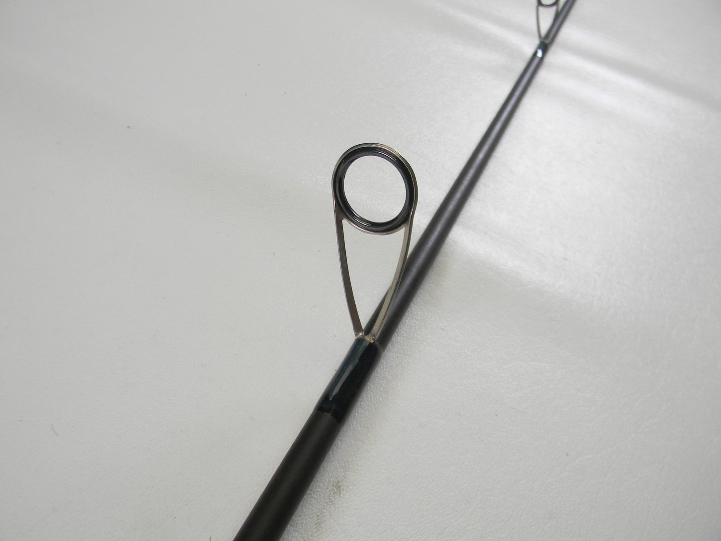 Close-up of a St. Croix Physyx PHXS710MMF 7'10" Medium used spinning rod in very good condition, highlighting the metal guide ring—ideal for anglers interested in pre-owned gear or trading in for store credit.
