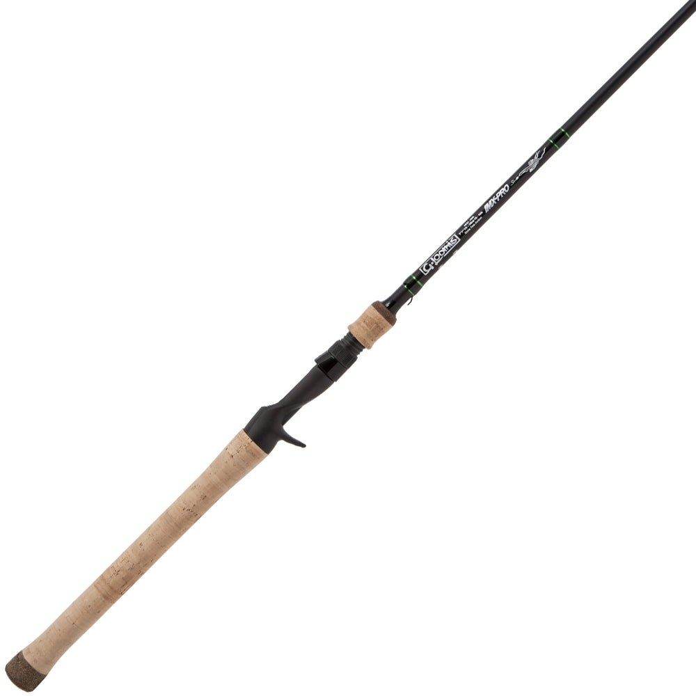 The G. Loomis IMX-PRO 954C FPR Casting Rod - Flip/Punch features a cork handle, black reel seat, slim black rod design, and green and white labeling near the handle.