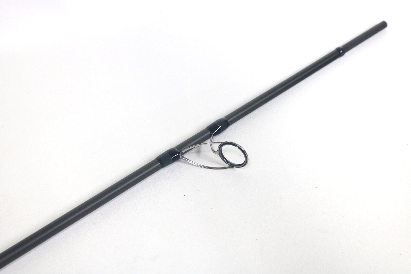 A close-up of the Megabass Cookai Inshore Spinning Rod (CK810MHS) in black, highlighting a metal line guide against a white background—ideal for showcasing this used, excellent-condition Megabass rod for our Trade-In Program.