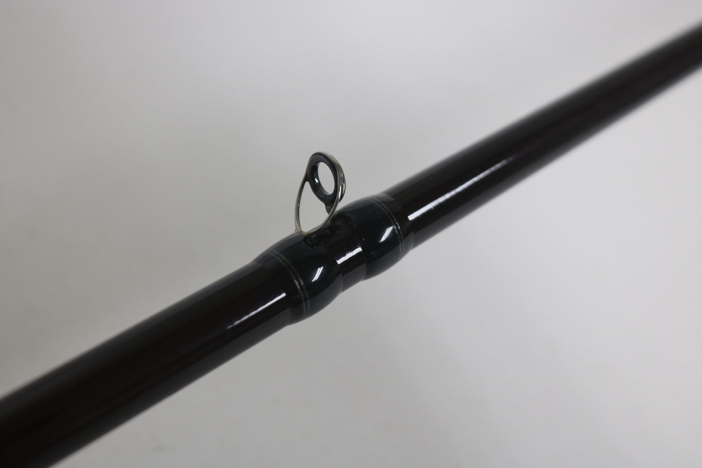 A close-up of the Legit Design Wild Side WSC-G66ML 6'6" Medium Light Used Casting Rod (Fair Condition) shows its metal line guide, highlighting gear you can trade in for store credit through our Rod and Reel Trade-In Program.