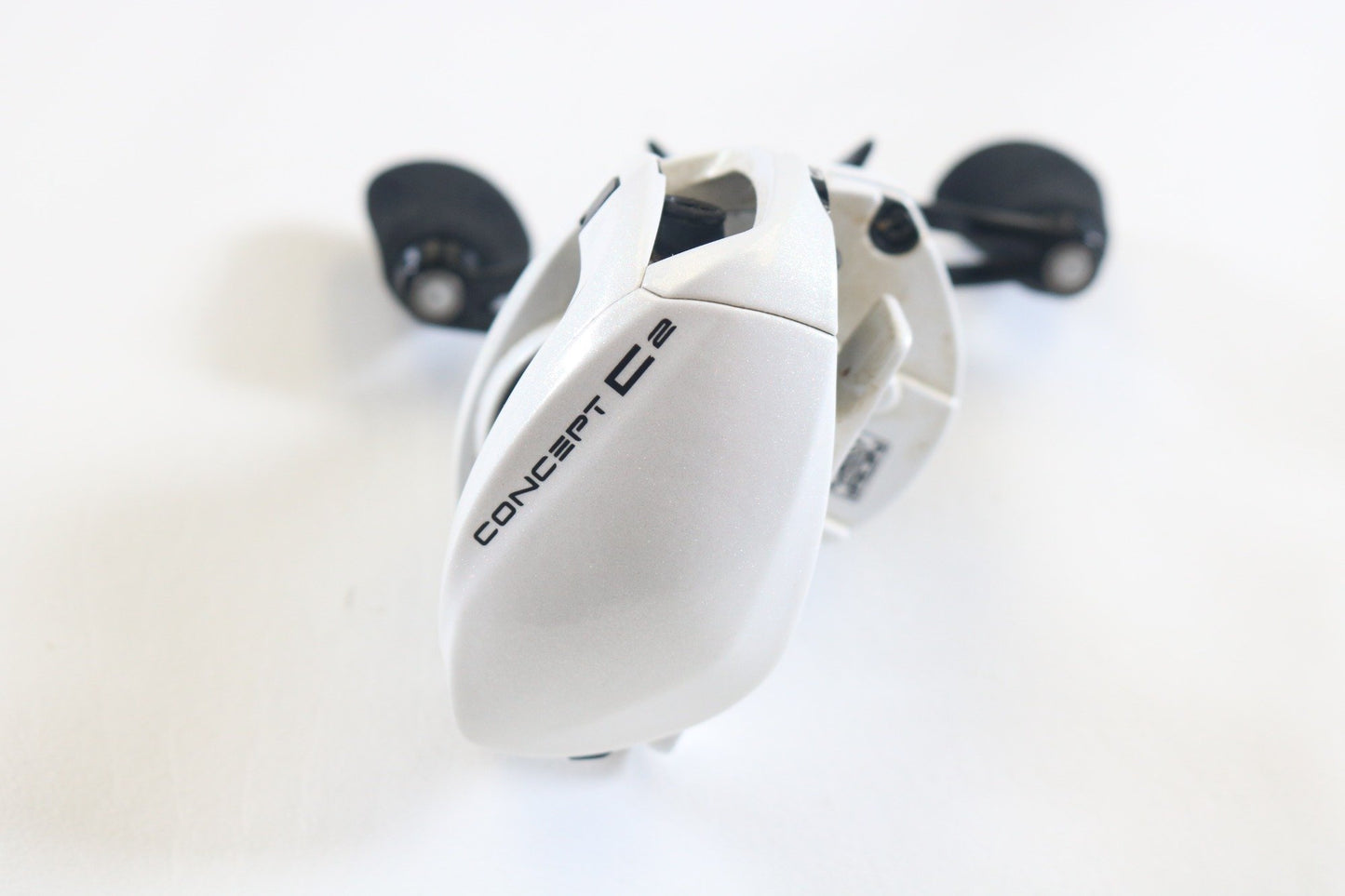 A close-up of a 13 Fishing Concept C2 C2-7.5-LH used casting reel in very good condition with black handles—ideal for quality gear seekers or those trading in through our Rod and Reel Trade-In Program for store credit.