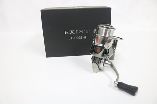 A Daiwa Exist LT2000S-H JDM 5.8:1 spinning reel (used, very good condition) is shown in front of a black box on a white background.