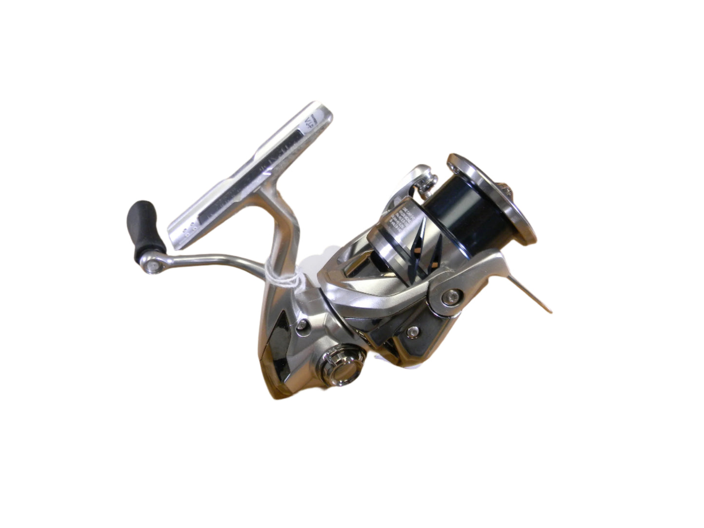 The Shimano Stradic ST2500HGFM, a sleek silver and black spinning reel with a crank handle, features a modern design with a metallic finish and ergonomic grip. Ideal for upgrading used gear during any Rod and Reel Trade-In event.