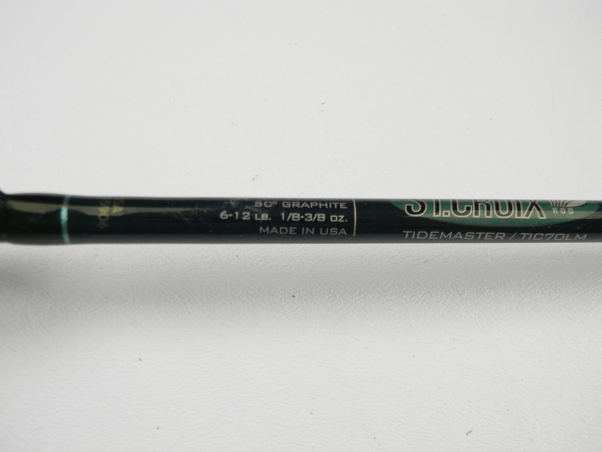 Close-up of a St. Croix Tidemaster TIC70LM 7'0" Light Casting Rod in excellent used condition, text shows specs and branding, ideal for your Rod and Reel Trade-In or upgrading your gear.