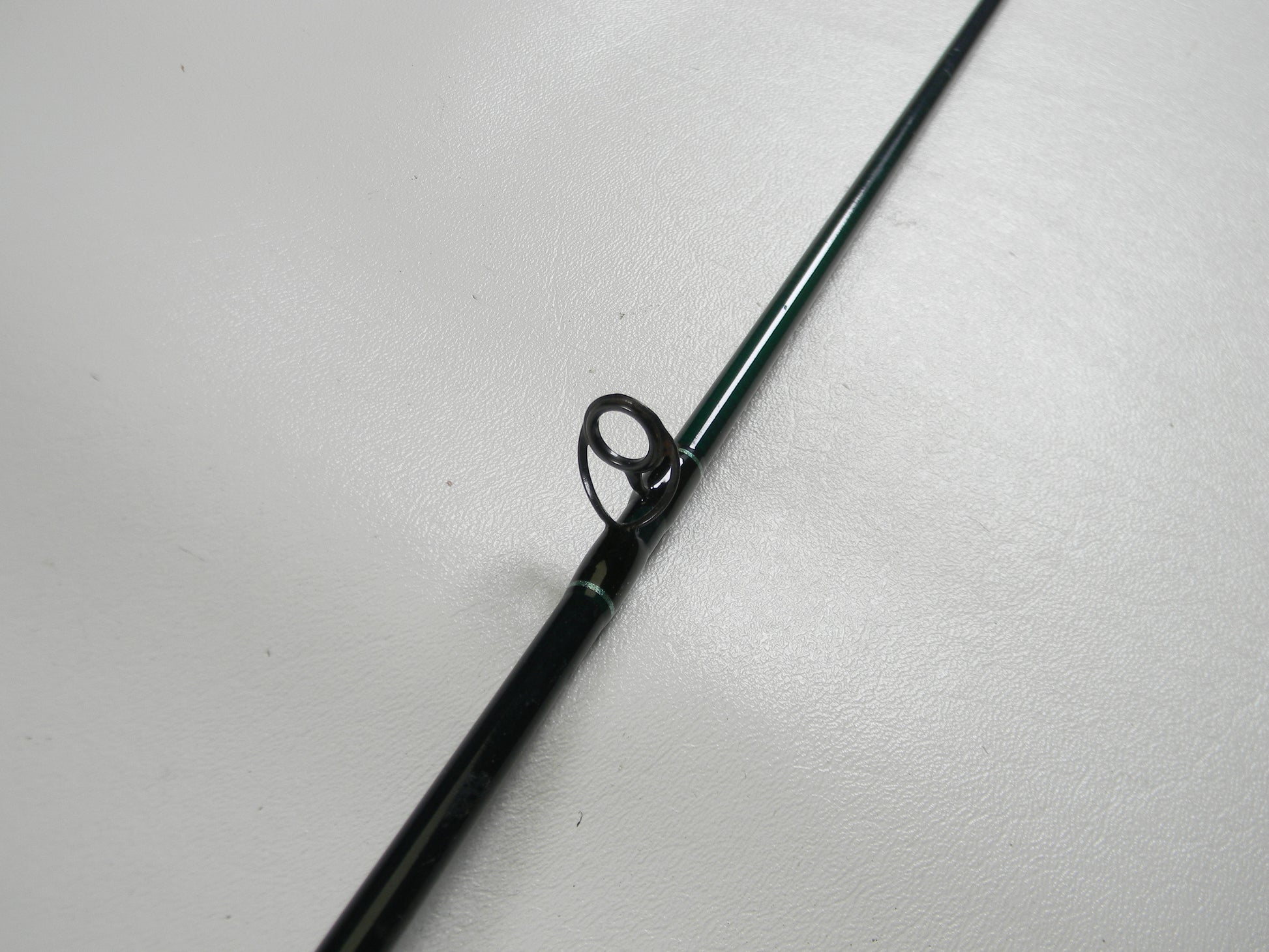 A close-up of the St. Croix Tidemaster TIC70LM 7'0" Light Used Casting Rod in excellent condition, highlighting a line guide—ideal for anglers considering our Rod and Reel Trade-In Program for store credit on used gear.