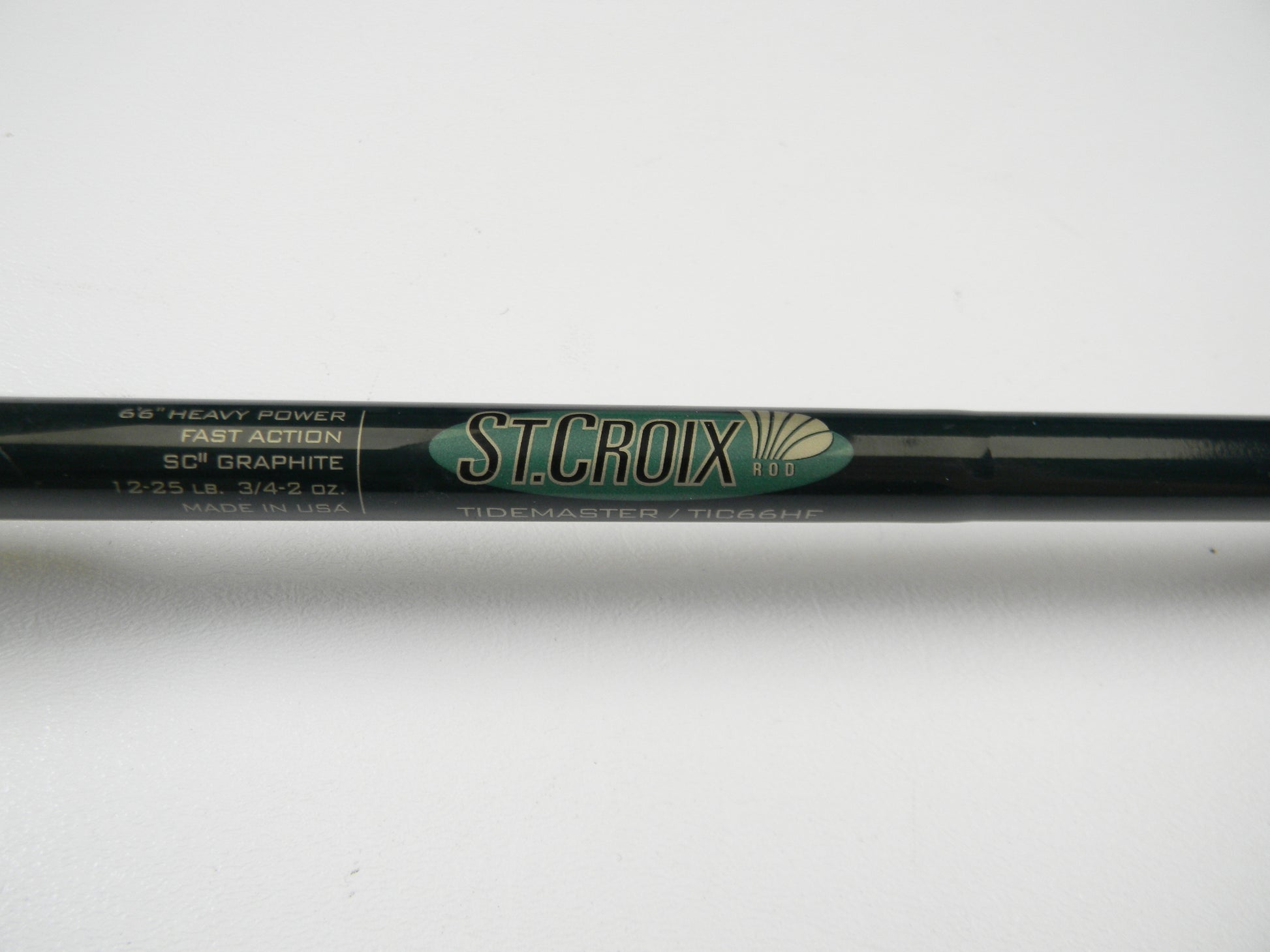 Close-up of a St. Croix Tidemaster TIC66HF 6'6" Heavy - Used Casting Rod displaying "SCII Graphite, Fast Action, 1-2.5 lb. 3/4-2 oz., Made in USA." Ideal for the Rod and Reel Trade-In Program where you trade used gear for store credit on your next adventure.