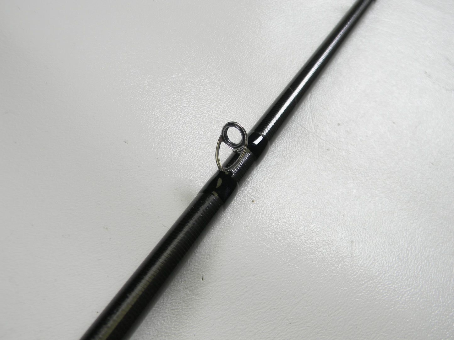 Close-up of a 13 Fishing Envy Black 3 EB3C71M 7'1" Medium Used Casting Rod in excellent condition, highlighting a line guide—ideal for evaluating gear for our Rod and Reel Trade-In and store credit offers.