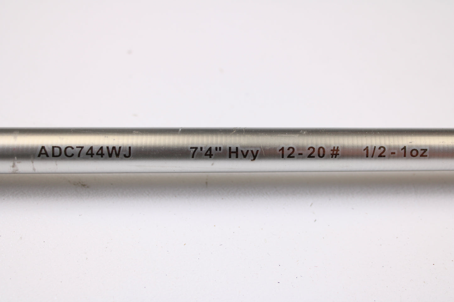 A close-up of the Denali Android ADC744WJ 7'4" Heavy Used Casting Rod in good condition, showing "ADC744WJ 7'4" Hvy 12-20# 1/2-1oz" text, ideal for our trade-in program or your used gear collection, on a white background.