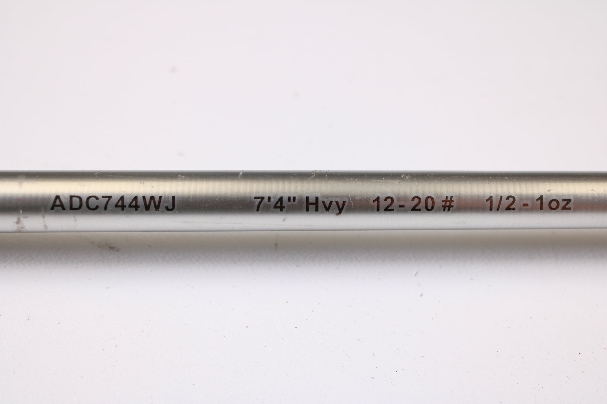 A close-up of the Denali Android ADC744WJ 7'4" Heavy Used Casting Rod in good condition, showing "ADC744WJ 7'4" Hvy 12-20# 1/2-1oz" text, ideal for our trade-in program or your used gear collection, on a white background.