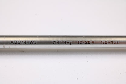 A close-up of the Denali Android ADC744WJ 7'4" Heavy Used Casting Rod in good condition, showing "ADC744WJ 7'4" Hvy 12-20# 1/2-1oz" text, ideal for our trade-in program or your used gear collection, on a white background.