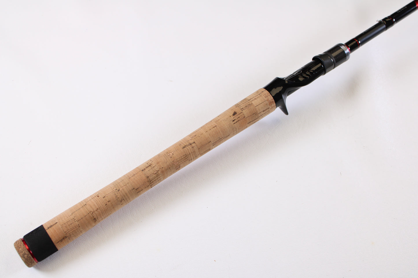 A close-up of the Daiwa DXB DXBT751HRB-G 7'5" Heavy Glass used casting rod in excellent condition, featuring a cork handle and black reel seat—perfect for those considering our rod trade-in program or store credit for used Daiwa gear.