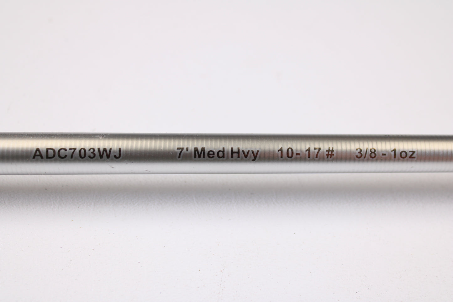 A close-up of the Denali Android ADC703WJ 7'0" Medium Heavy Used Casting Rod in good condition, showing black and red labeling on a silver surface, featured in our used gear trade-in program against a white background.