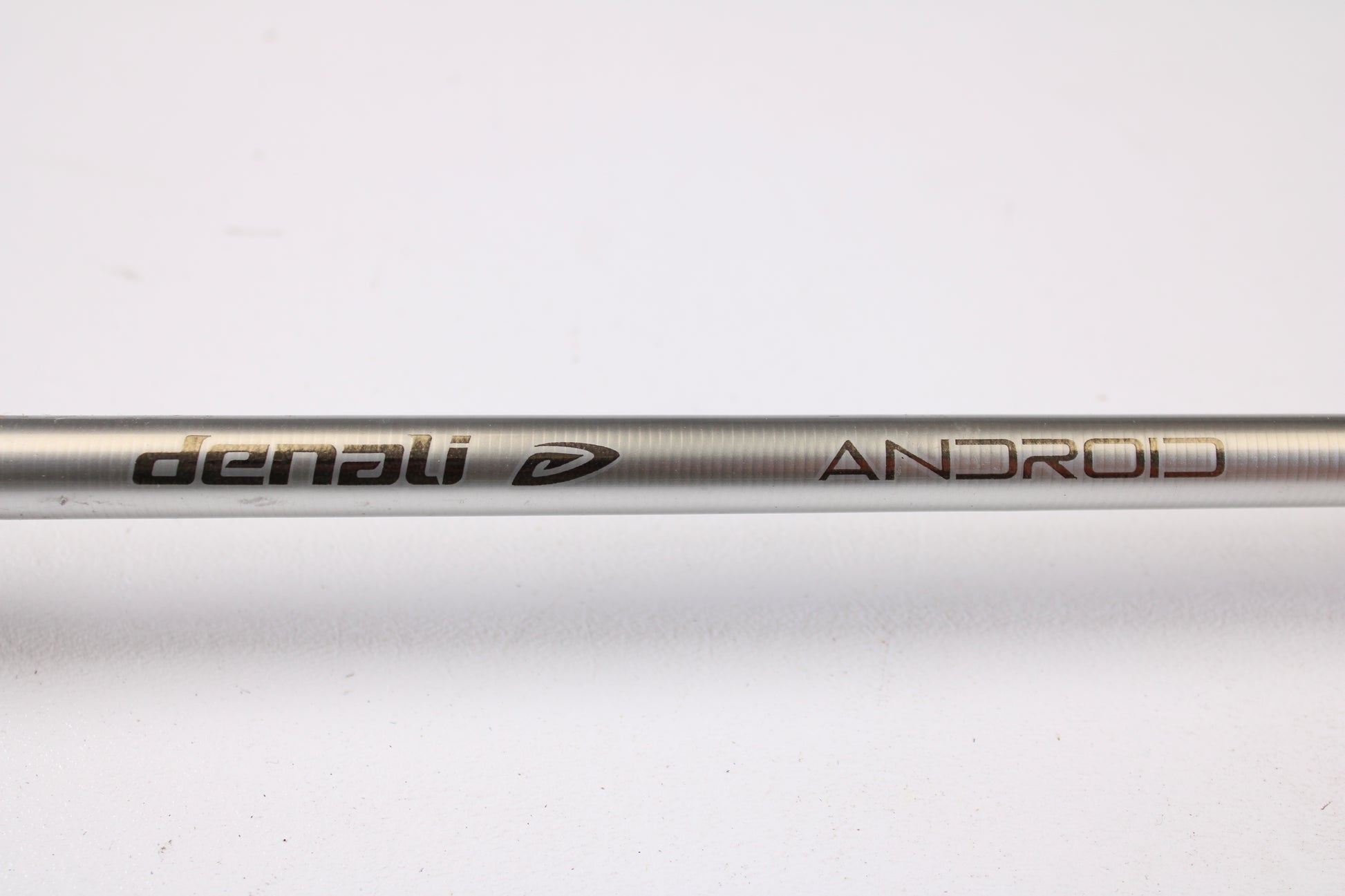 A close-up of the Denali Android ADC704WJ 7'0" Heavy Used Casting Rod in good condition, showing "denali" and "ANDROID" printed on its metallic surface—ideal for our Rod and Reel Trade-In Program.