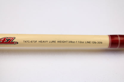 A close-up of the Doomsday Tackle Co. The 47 T47C-673F 7'3" Heavy Used Casting Rod (Very Good), specs: "HEAVY 3/8oz-1 1/2oz LURE, 12lb-30lb LINE," ideal for rod and reel trade-in, on a cream background with red accent.