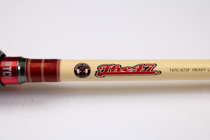 A close-up of the Doomsday Tackle Co. The 47 T47C-673F 7'3" Heavy used casting rod in very good condition—beige with red accents, ideal for anglers interested in pre-owned gear or considering a trade-in.