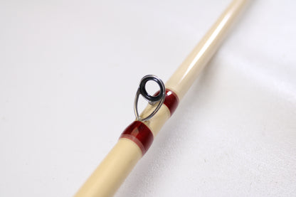 Close-up of a Doomsday Tackle Co. The 47 T47C-673F 7'3" Heavy used casting rod in very good condition, featuring a beige finish and metal guide ring—ideal for value-seekers using our rod and reel trade-in program.