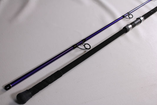Two ODM Rods The Jigster 11'0" Fast 2 Piece used spinning rods in mint condition lie parallel on a white surface—ideal for upgrading your gear or using our rod and reel trade-in program for store credit.