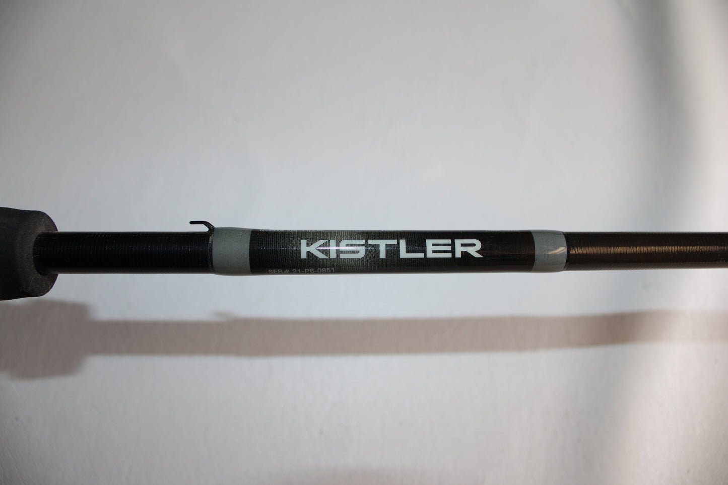 Close-up of a Kistler Graphite GR705H 7'0" Heavy used casting rod in very good condition, featuring the Kistler brand name printed in white on the black shaft, set against a plain white background.