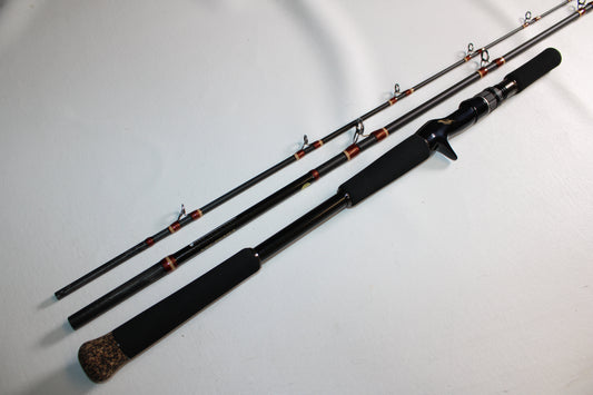 A Megabass Valkyrie VKC-66XH 3 Piece Travel Rod, a used casting rod in excellent condition, is laid out on a white surface.