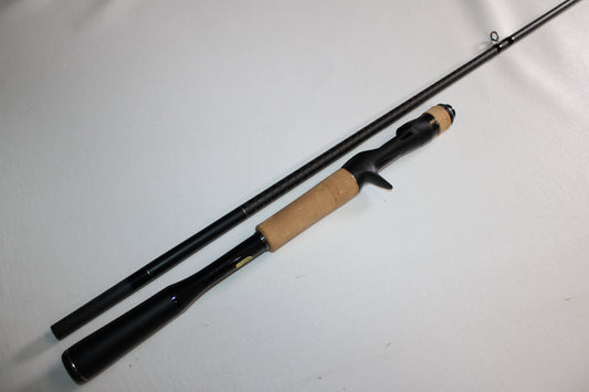 A Shimano Expride 172H JDM 2-Piece Casting Rod in excellent used condition, with a cork handle and black reel seat. Both sections are separated and laid side by side on a white surface.